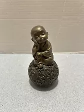 Daydreaming Baby Buddha Statue On Decorative Orb 5.5” H Bronze Resin