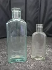 Lot of 2 Antique Glass Bottle for Three in One Oil Co. 1 each Aqua & Clear