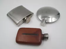 COLLECTION THREE MEN'S HIP FLASKS. STAINLESS STEEL AND LEATHER. 1980'S Rare