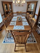 Kincaid solid oak dining room table, 8 chairs, 2 corner hutches. Table has...