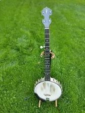 Five string banjo, open back, custom neck, ode aluminum pot, foam core case.