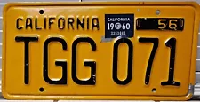 1956 California single black on yellow license plate with a 1960 sticker TGG071