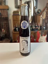 This Sale Is For (1) 1985 Jimmy Carter 10oz Coca Cola Bottle.Gold Cap