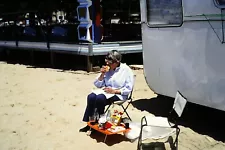 Woman Outside Travel Trailer Eating A Sandwich 4x6 Vintage 1978 Photo Reprint