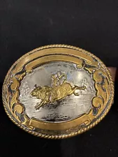 Riding bull belt buckle well worn German silver by Tony Sama