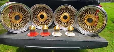 (4) 17 by 9 center gold 100 radical authentic dayton wire wheels caps & adaptors