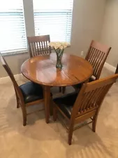 Used solid oak dining table and chairs in excellent condition.