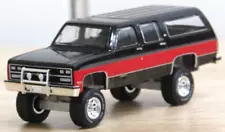 greenlight Custom lifted black red square body Chevy Suburban 1/64..