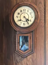 Antique wall-hung clock. Wooden body, nice chime. 21" tall.