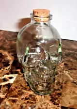 SMALL SKULL BOTTLE GREEN GLASS NICE CORK, MARKED WITH M ON THE BOTTOM, 4" TALL,