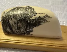 A scrimshaw Alaskan carvings of a bear on mammoth ivory.