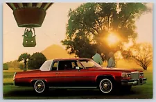 Automobiles~Red 1980 Cadillac Coupe DeVille & Hot Air Balloon~Vintage Postcard