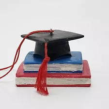 Graduation Cap With Tassels Placed On Books