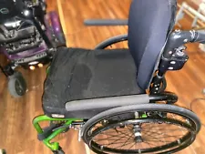 Ti lite manaul wheelchair green in color comes apart for easy storage