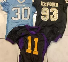 Three High School Football Jerseys , One Medium And Two Large