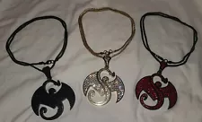 Gold bling, Red bling, and Black Diamond Strange Music pendants