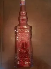 One 12.5" Tall Glass Bottle in Red w/Raised Design on Front & Back w/Cork