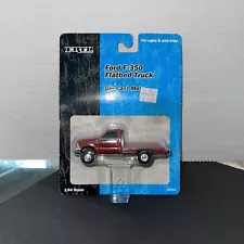 1/64 DARK RED FORD F-350 FLATBED TRUCK – ERTL (2000)