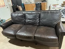 Extremely comfortable leather sofa. Comes with throw pillows. Has some scratches