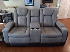 For Sale: New condition. Ashley two-seat power recliner sofa with console