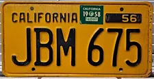 1956 California single black on yellow license plate with a 1958 sticker JBM675