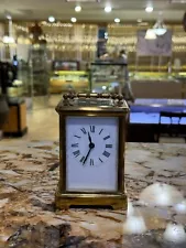 vintage carriage clock brass and glass with porcelain face with Roman numerals