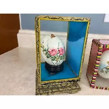 Collection Of Hand Painted Art Egg Shells In Glass Displays