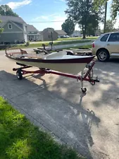 single rowing scull boat with oars and trailer