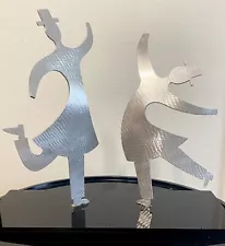 Two Rabbis in a joyous dance. Aluminum Judaical sculpture on plexiglass base