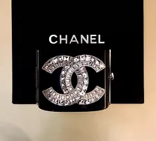 CHANEL JET BLACK RESIN CUFF WITH BAGUETTE RHINESTONE LOGO