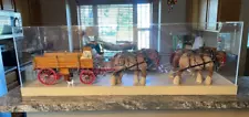 Custom made wooden farm wagon pulled by 4 horses